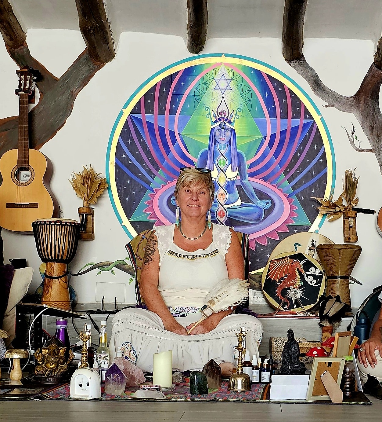 Sue Holmes completing a healing session with someone lay down next to her